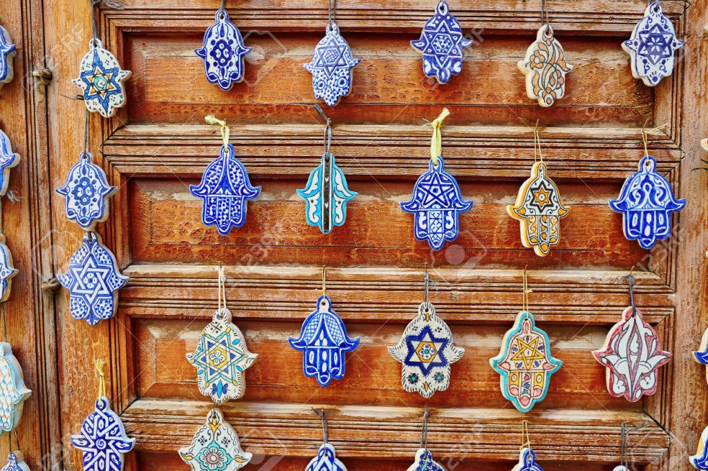 Selection of traditional Moroccan amulets, khamsa, providing defense against the evil eye, on a market in Fes